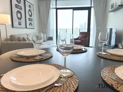 a table with plates and wine glasses on it at Canal View - 2-BHK - Creek Harbour - Central - Lux in Dubai