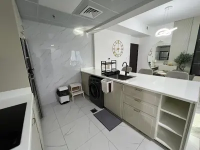 a kitchen with a sink and a washing machine at Italian-Style 2BR - Near Beach, Metro and Mall in Dubai