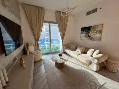 a living room with a couch and a table at Italian-Style 2BR - Near Beach, Metro and Mall in Dubai