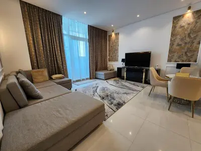 a large living room with a couch and a table at Stylish Suites 1 Br Business Bay in Dubai