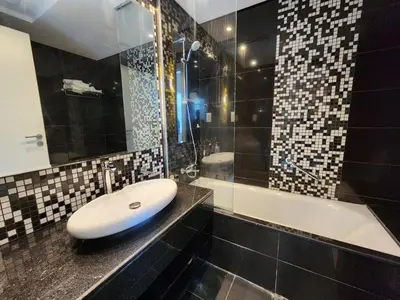 a bathroom with a sink and a bath tub at Stylish Suites 1 Br Business Bay in Dubai
