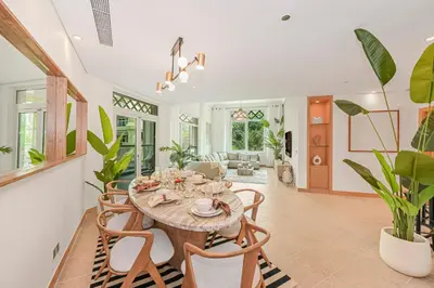 a dining room with a table and chairs at Elegant Private Room at The Palm with Beach & Pool Access in Dubai