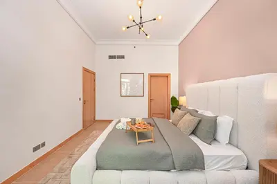 a living room with a couch and a table at Elegant Private Room at The Palm with Beach & Pool Access in Dubai