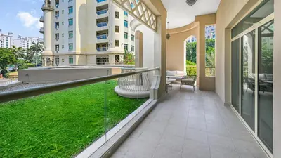 a balcony with a green lawn in a building at Elegant Private Room at The Palm with Beach & Pool Access in Dubai