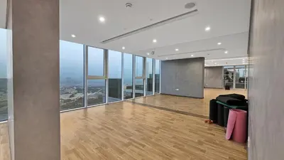 an empty office with a view of a city at 1 Residences High-Floor Apt with City View, Al Kifaf in Dubai