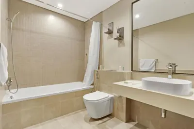 a bathroom with a sink and a toilet and a tub at 1 Residences High-Floor Apt with City View, Al Kifaf in Dubai