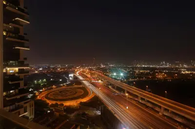 a city at night with traffic on a highway at 1 Residences High-Floor Apt with City View, Al Kifaf in Dubai