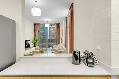 a kitchen with a white counter top with a appliance at Canal View, Partial Burj Khalifa View, Brand New in Dubai