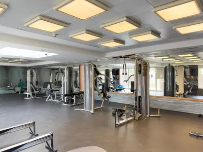 a gym with treadmills and elliptical machines at GuestReady - Furnished 1BR+Sofa | Al Alka Greens in Dubai