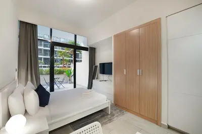 a bedroom with a bed and a large window at EasyGo- Spacious, Low Floor and Pool view STU in Dubai