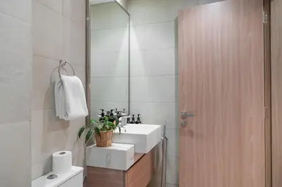 a bathroom with a sink and a mirror at EasyGo- Spacious, Low Floor and Pool view STU in Dubai