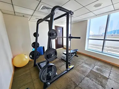 a gym with tread machines in a room with a window at Opposite JBR Beach - Modern Studio in Dubai