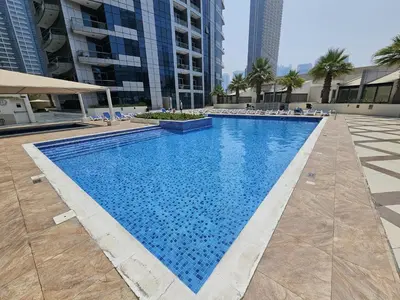 a large swimming pool in the middle of a building at Opposite JBR Beach - Modern Studio in Dubai