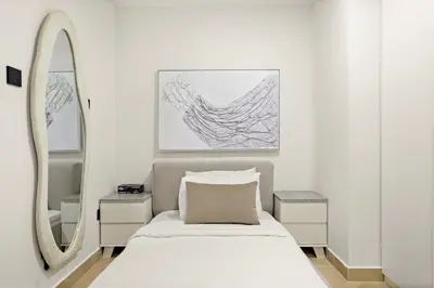 a bedroom with a bed and a mirror at Luxury 5BR Penthouse in Marina l Private Jacuzzi & Sauna in Dubai