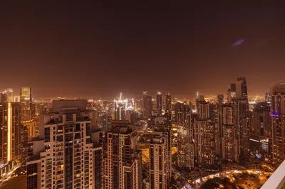a view of a city at night at Luxury 2BR with Burj Khalifa View l High Floor at Paramount in Dubai