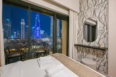 a bedroom with a large window with a view of a city at Burj Royale Luxury 2BR Burj Khalifa & Fountain View 5 Min Walk Dubai Mall, 500MBPS Wifi in Dubai