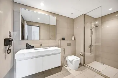 a bathroom with a sink and a toilet and a shower at Burj Royale Luxury 2BR Burj Khalifa & Fountain View 5 Min Walk Dubai Mall, 500MBPS Wifi in Dubai