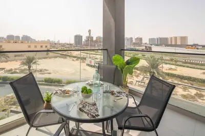 a glass table and chairs in a room with a view at Frank Porter - Hyati Avenue in Dubai