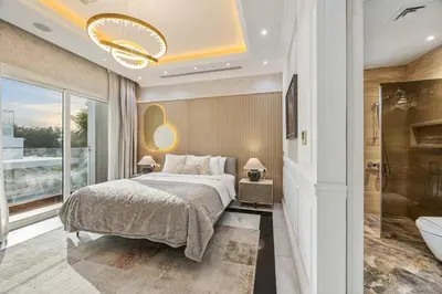 a bedroom with a bed and a bathroom with a tub at Luxury Villa with Pool, Cinema & Spa - Jumeirah Golf in Dubai