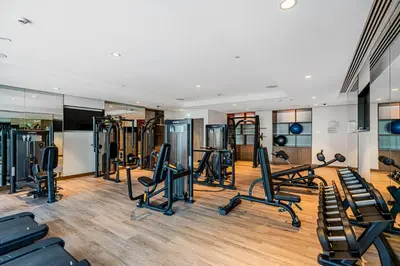 a gym with treadmills and elliptical machines at Amazing 3BR APT Near Burj Khalifa and Dubai Mall in Dubai