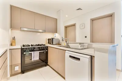 a kitchen with a stove and a sink at Amazing 3BR APT Near Burj Khalifa and Dubai Mall in Dubai