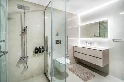 a bathroom with a shower and a toilet and a sink at MAG218 Cozy 1BHK Near Marina Walk in Dubai