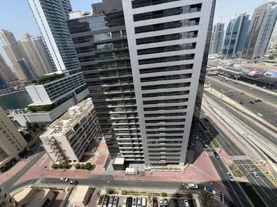 an aerial view of a tall building in a city at Cozy 1BR apartment in Marina in Dubai