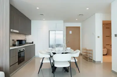 a kitchen and dining room with a table and chairs at Sea and Palm View 2B Beachfront Luxury Emaar Beachfront in Dubai