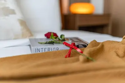 a piece of paper on a bed with a red pair of scissors at DAYF-SKGMAR Upgraded Huge High-Floor Studio with Dubai Frame View in Dubai