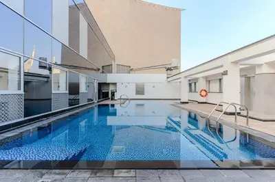 a large swimming pool in the middle of a building at DAYF-SKGMAR Upgraded Huge High-Floor Studio with Dubai Frame View in Dubai