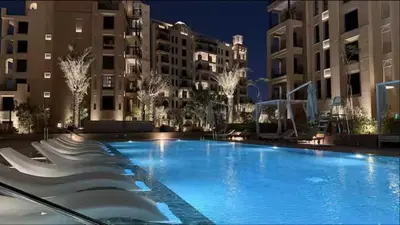 a large swimming pool in front of some buildings at Vogue Madinat Jumeirah Living Jadeel near Burj AlArab, Two-Bedroom Apartment with Large Balcony and Pool View, Access to All Amenities in Dubai