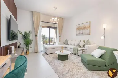 a living room with a couch and a table at Vogue Madinat Jumeirah Living Jadeel near Burj AlArab, Two-Bedroom Apartment with Large Balcony and Pool View, Access to All Amenities in Dubai
