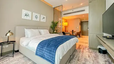 a bedroom with a large bed and a living room at Stunning Bay View Studio in Center of Dubai in Dubai