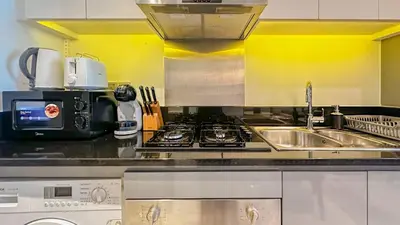 a kitchen with a sink and a stove at Stunning Bay View Studio in Center of Dubai in Dubai