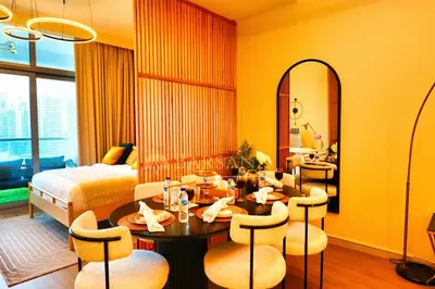 a hotel room with a bed and a table and chairs at Barsana - Premier 3Bed Suite - Marina & Sea Views in Dubai