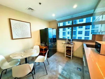 a kitchen with a table and chairs and a kitchen with a counter at Barsana - Premier 3Bed Suite - Marina & Sea Views in Dubai