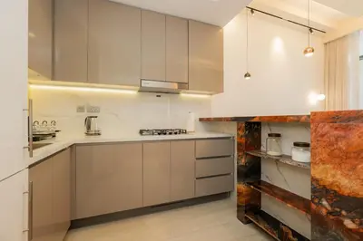 a kitchen with white cabinets and a counter top at Elite Escape - 1 BHK Getaway in Azizi Riviera 18 in Dubai