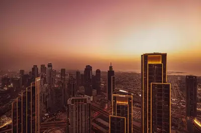a view of a city skyline at sunset at Luxury 2BR Sea Burj views Khalifa infinity pool in Dubai
