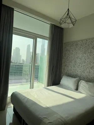 a bedroom with a bed and a large window at Apartment Downtown Dubai in Dubai