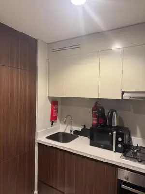 a kitchen with a sink and a microwave at Apartment Downtown Dubai in Dubai