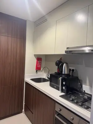 a kitchen with a microwave and a sink and a stove at Apartment Downtown Dubai in Dubai