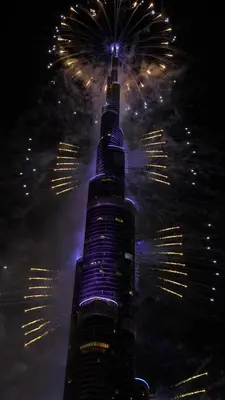 a tall building with fireworks in the sky at Private Room in Luxurious 3BR Apartment with BURJ KHALIFA view in Downtown near Dubai Mall in Dubai