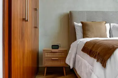 a bedroom with a bed and a nightstand next to a bed sidx sidx sidx at Private Room in Luxurious 3BR Apartment with BURJ KHALIFA view in Downtown near Dubai Mall in Dubai