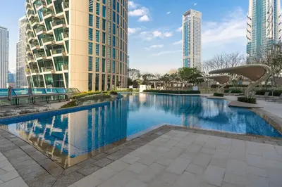 a swimming pool in a city with tall buildings at Private Room in Luxurious 3BR Apartment with BURJ KHALIFA view in Downtown near Dubai Mall in Dubai