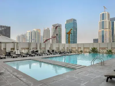 a large swimming pool with a city skyline in the background at FIRST CLASS 1BR Luxury Meets Simplicity in Dubai