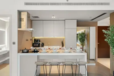 a kitchen with a large island with bar stools at FIRST CLASS 1BR Luxury Meets Simplicity in Dubai