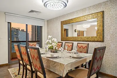 a dining room with a table and a mirror at FIRST CLASS 3BR Sea View Near JBR Beach in Dubai