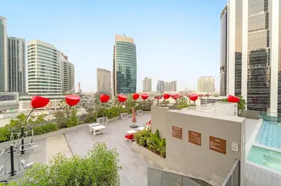 a rooftop of a building with a pool and buildings at FIRST CLASS 2BR Pool View and near Dubai Mall in Dubai
