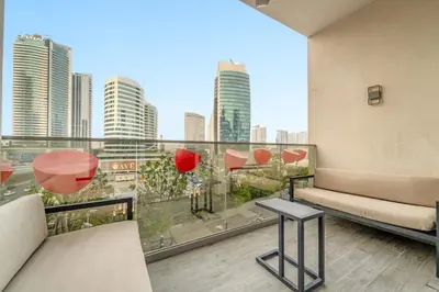 a balcony with a view of a city skyline at FIRST CLASS 2BR Pool View and near Dubai Mall in Dubai