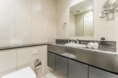 a bathroom with a sink and a mirror at Furnished Studio Near Circle Mall, Close to Parks, Jogging Tracks, Bus Stops And Grocery Stores - Damac Ghalia, JVC by Deluxe Holiday Homes in Dubai